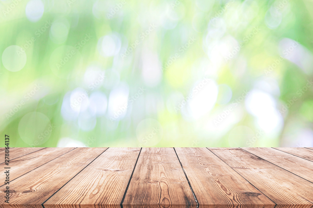 Abstract spring or summer with bokeh background and wooden tabletop Abstract spring or summer with bokeh background and wooden tabletop