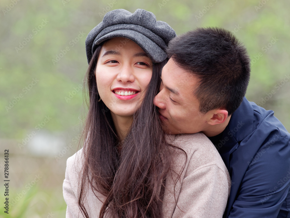 Close up photo of cheerful excited glad careless happy with toothy beaming smile brunette attractive Chinese woman and with her handsome boyfriend, lifestyle, happiness and lover concept. Close up photo of cheerful excited glad careless happy with toothy beaming smile brunette attractive Chinese woman and with her handsome boyfriend, lifestyle, happiness and lover concept.