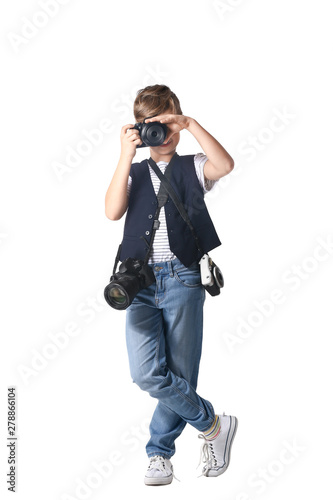 Cute little photographer with professional cameras on white background