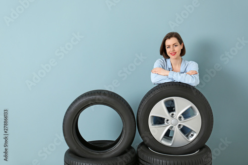 Young woman with car tires ...