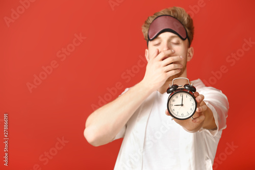 Sleepy young man with mask ...