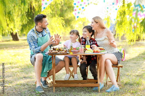Happy family having picnic ...