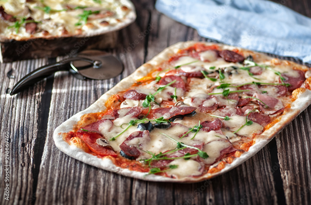 Pizza with cheese and salami. on a wooden table Pizza with cheese and salami. on a wooden table