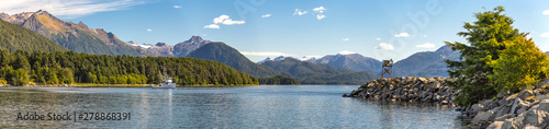 Panoramic view of the harbor with a fishing boat sailing in the distance in Sitka, Alaska. photo