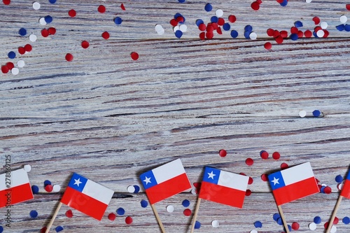 September 18, happy independence day of Chile. memorial day for independence. the concept of patriotism. mini flags with confetti on white wooden background