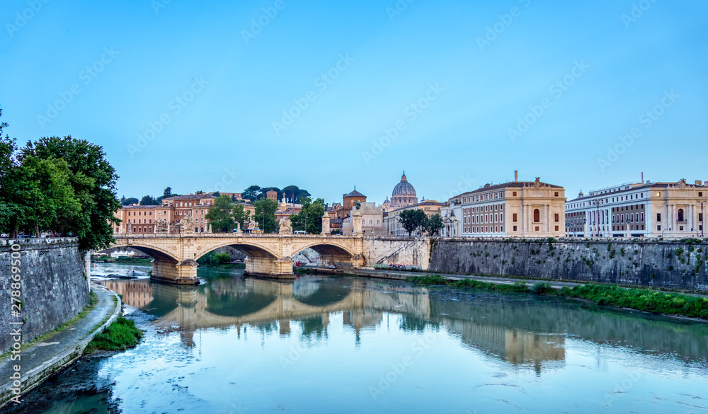 Emanuele II bridge and St. Peter's Basilica at dawn.