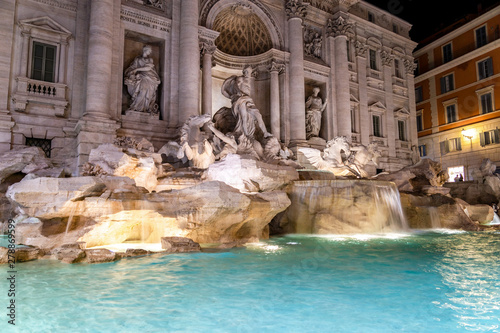 Illuminated Trevi Fountain (Fontana di Trevi) at night, famous fountain in the Trevi district of Rome - Italy.