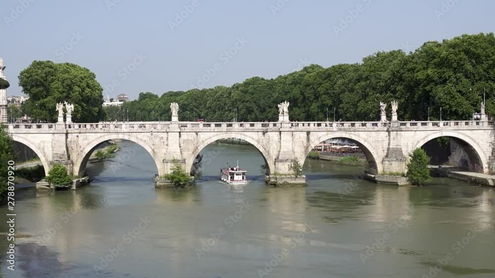Tourist boat passes under Ponte Sant'Angelo in Rome - Italy Tourist boat passes under Ponte Sant'Angelo in Rome - Italy