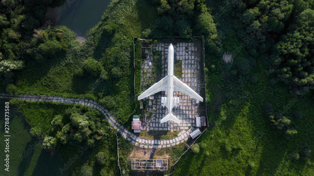 Fototapeta premium old abandoned plane standing in green field. aerial view, drone shot, bird's eye