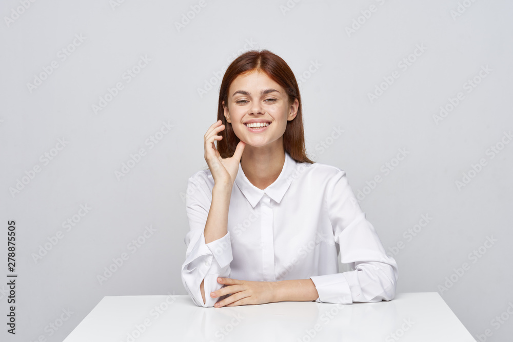 business woman sitting at desk and talking on phone business woman sitting at desk and talking on phone