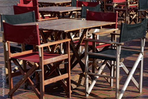 An empty outside cafe with tables and chairs