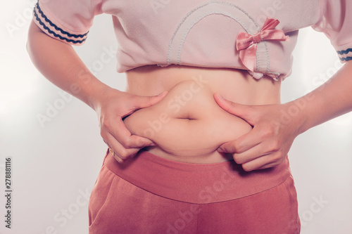 Women use both hands to squeeze the belly fat.