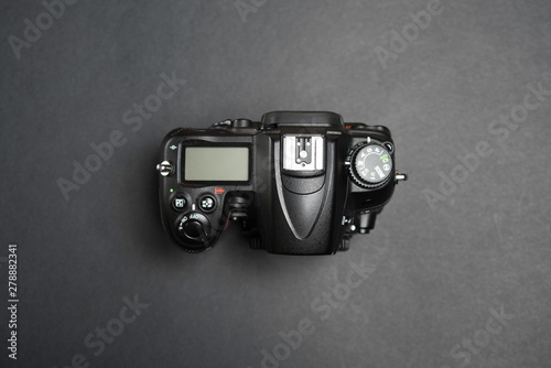 Digital Single Lens Reflex on black background without lens, body view from above on black background photo