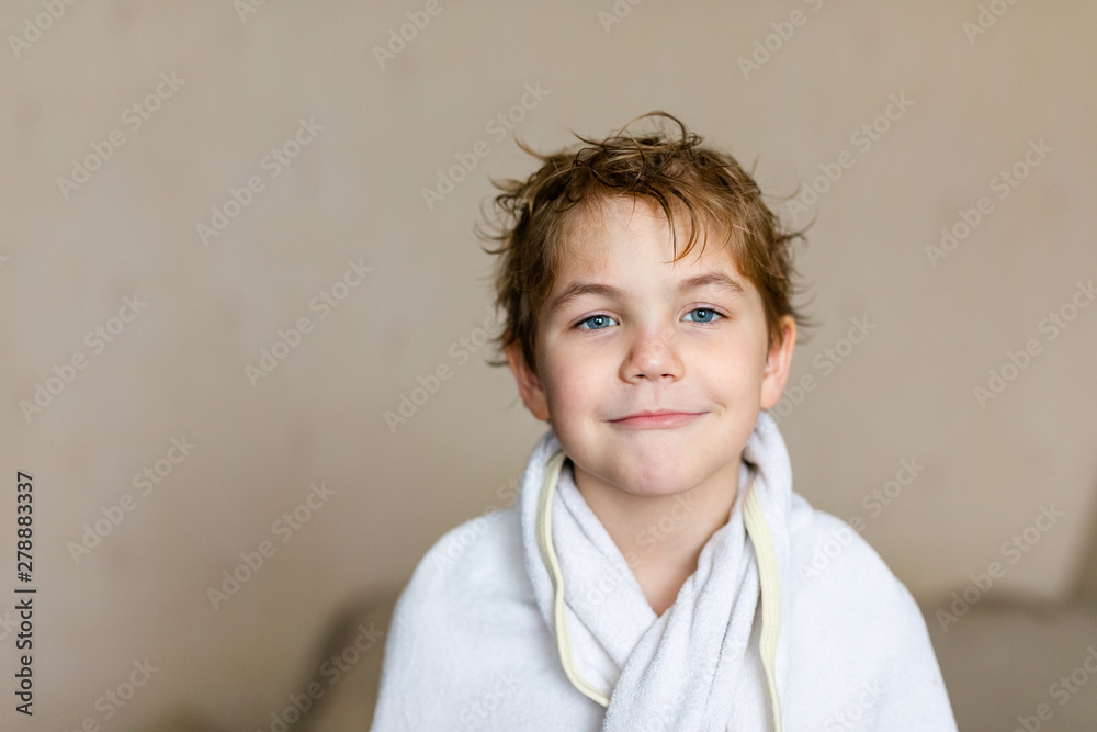 Blode caucasian boy after bath with wet hair and white towel on the head. Funny face, great smile, positive mood Blode caucasian boy after bath with wet hair and white towel on the head. Funny face, great smile, positive mood