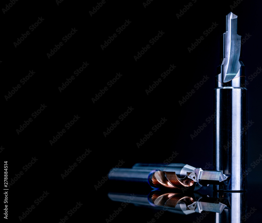Special tools isolated on dark background. Made to order special tools. Coated step drill and reamer detail. HSS cemented carbide. Carbide cutting tool for industrial applications. Engineering tools. Special tools isolated on dark background. Made to order special tools. Coated step drill and reamer detail. HSS cemented carbide. Carbide cutting tool for industrial applications. Engineering tools.