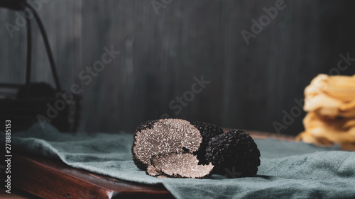 Black truffles mushrooms on rustic wooden table photo