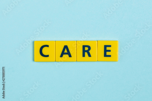 Care word on scrabble tiles