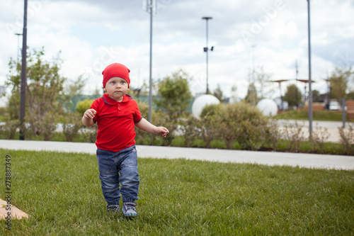 Happy small child on walk in a summer park. Rest in the city, outdoor