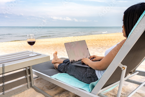 Woman using laptop on the beautiful beach © Quang