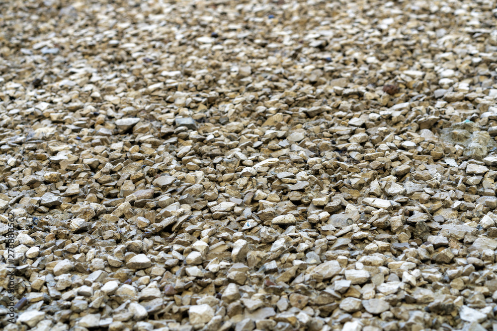 fine gravel road surface. Small stone glued with concrete. Small gravel pavement. Background type view of small rocks on a pavement road. fine gravel road surface. Small stone glued with concrete. Small gravel pavement. Background type view of small rocks on a pavement road.