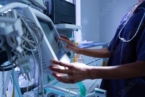 Surgeon using medical equipment in operating room of the hospital