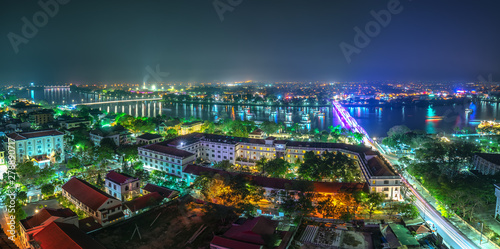 Panoramic city colorful night sparkling view from above in Hue, Vietnam.
