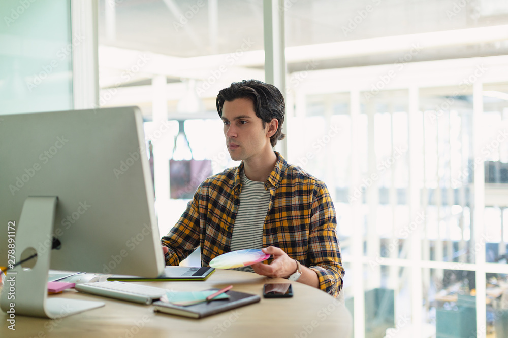 Male Graphic designer using graphic tablet at desk Male Graphic designer using graphic tablet at desk