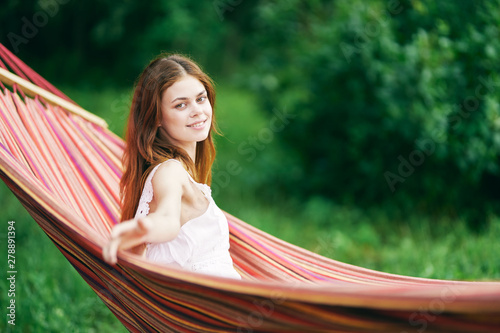 young woman reading a book in the park