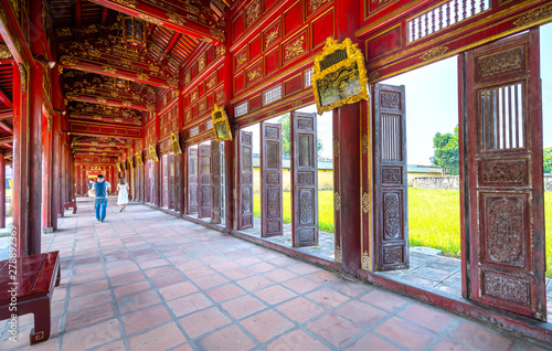 Tourists visit walk along wooden hallway corridors of the Thai Hoa Palace in the Imperial City in Hue, Vietnam.
