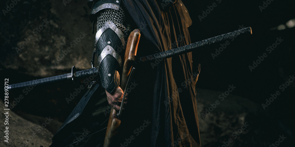 Mystery scarface knight in armor with sword and crossbow in the forest - obrazy, fototapety, plakaty 