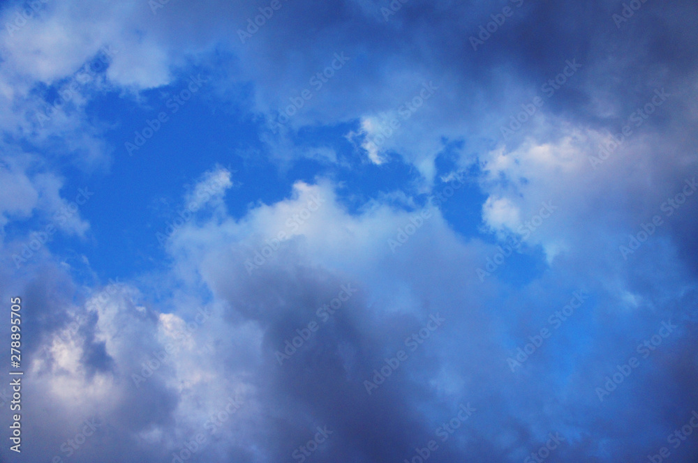 White and blue contrasting blue clouds in the sky.