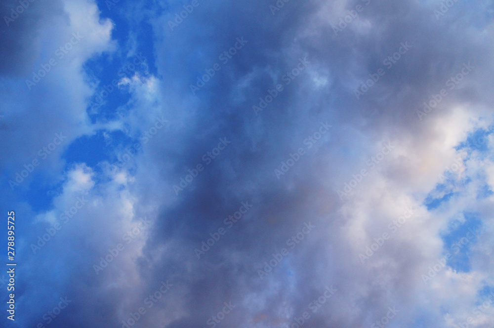 White and blue contrasting blue clouds in the sky.