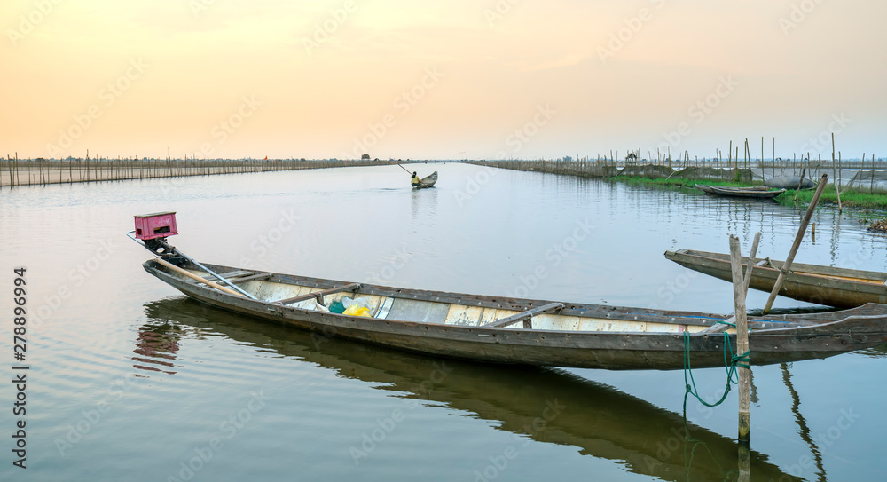 Fototapeta premium Wooden boat dock in Chuon lagoon, Hue, Vietnam. This is a living means of transportation in the flooded area in central Vietnam