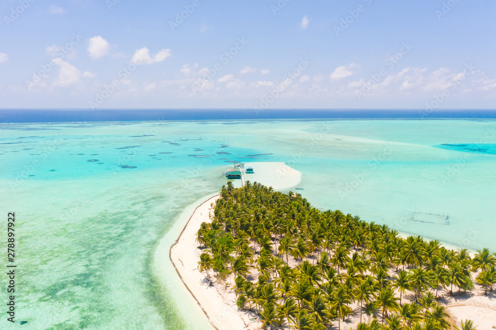 Seascape with a paradise island. Onok Island Balabac, Philippines. A small island with a white