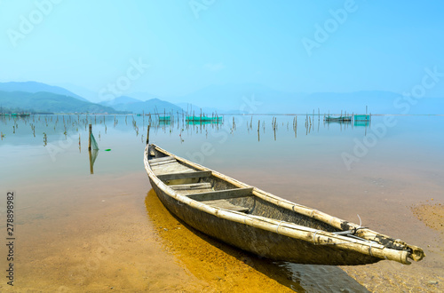 Lonely wooden fishing boat on the lagoon looking forward to going to the sea as a wish for people to look forward to good things in the vast sea