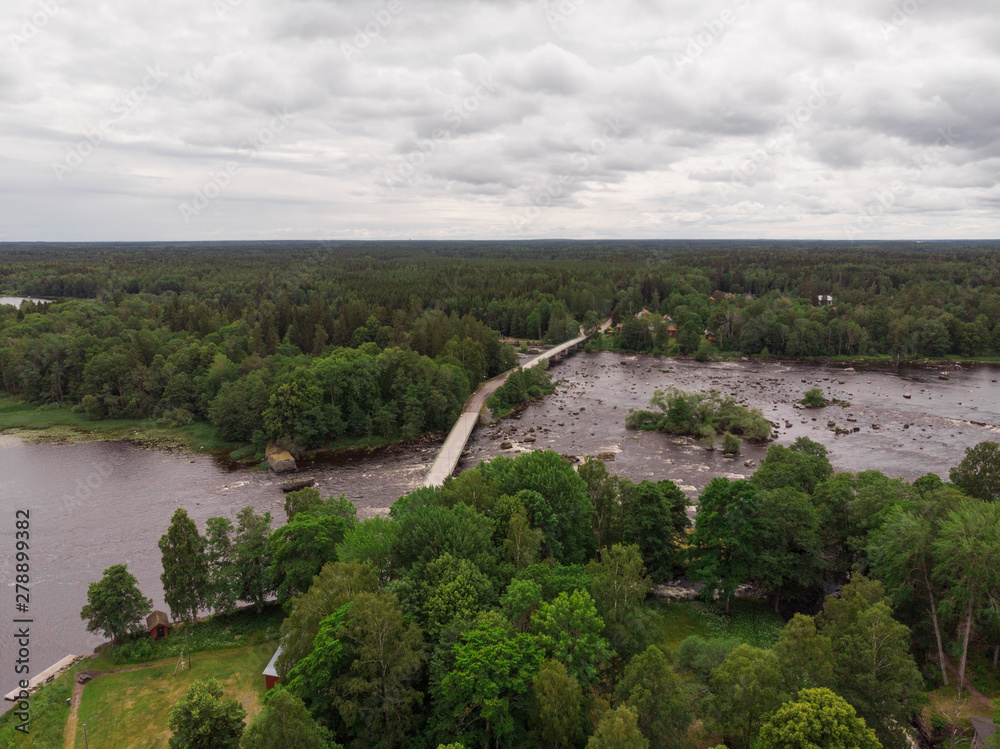 Aerial view of Gysinge with the bridge over the river Dalälven with the information house for the national park.