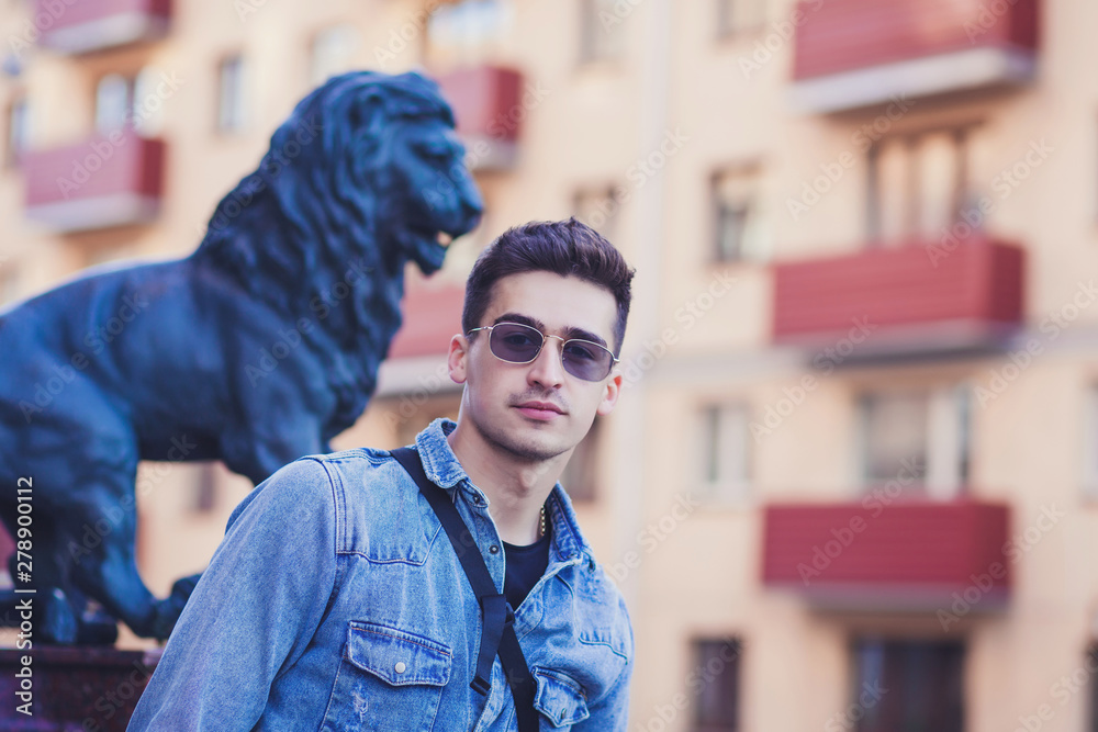 Fototapeta premium positive handsome man with glasses walking around the city
