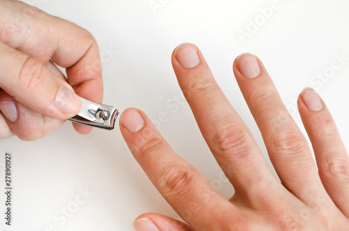 A young man does a manicure. Photo.