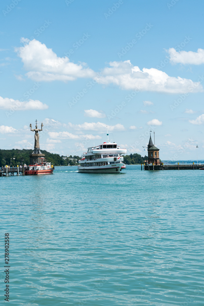 large passenger boat enters the historic harbor at Konstanz on Lake Constance