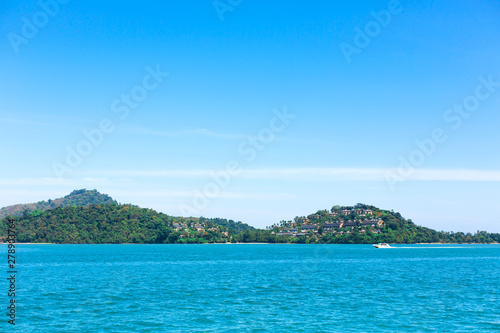View of a green island in the blue ocean