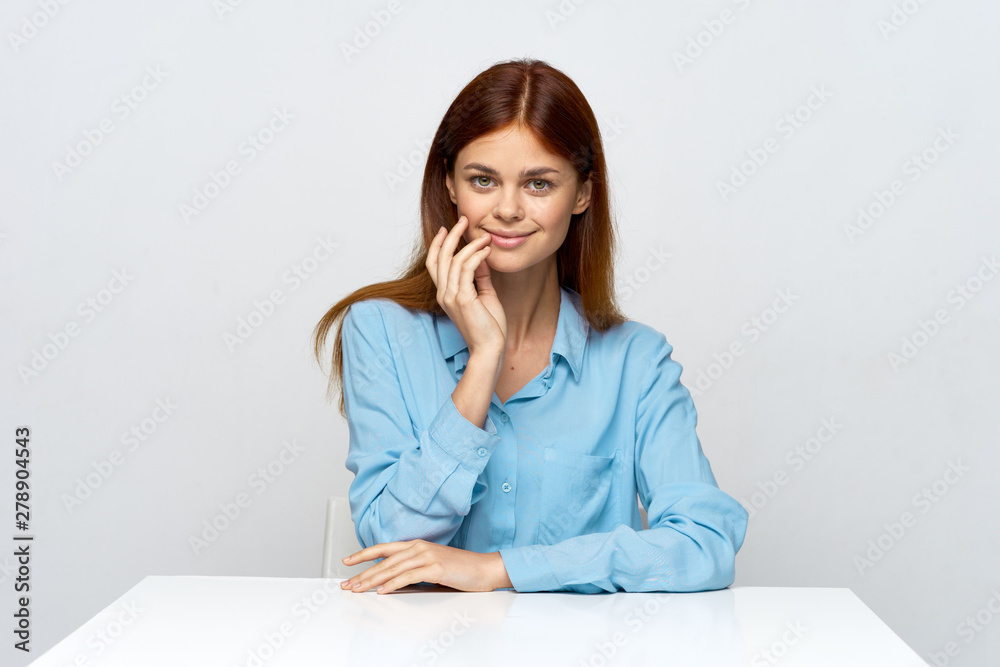 portrait of a young woman sitting at her desk portrait of a young woman sitting at her desk