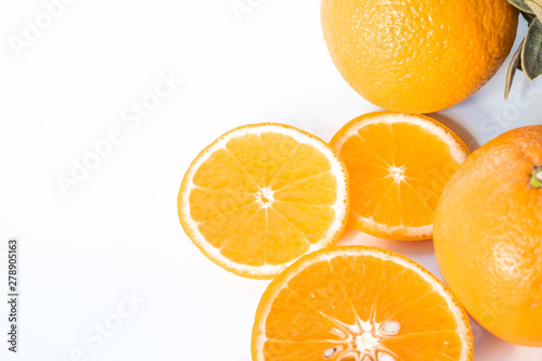 Sliced orange with green leaf isolated on white background