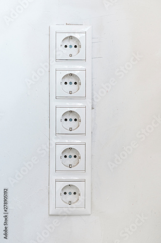 Electrical sockets on white wall photo