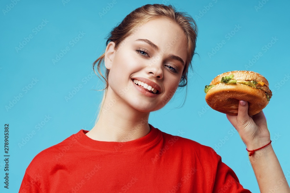woman with hamburger on white background woman with hamburger on white background