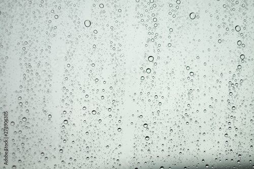 Close up Drops of water on the glass in the rainy season