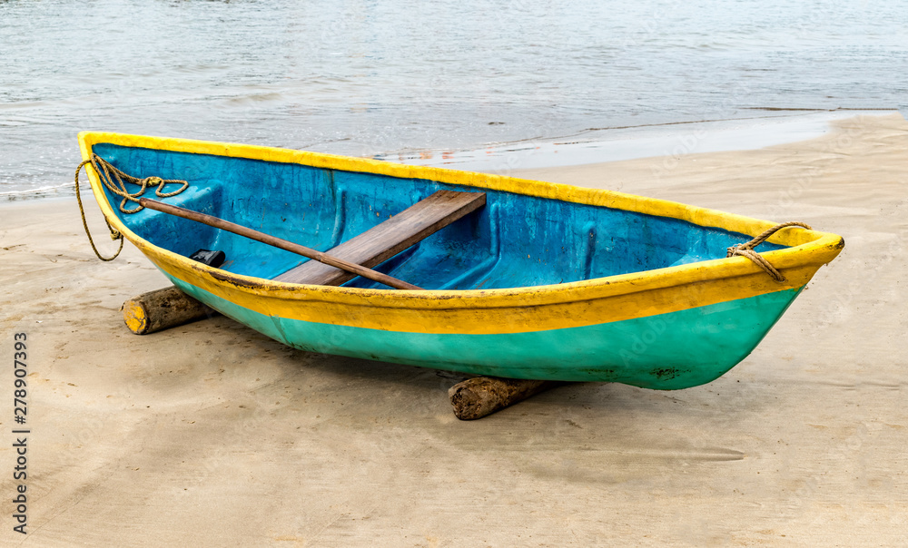 Beautiful photo of beached Fishing Canoe, the canoe is painted colorful in traditional asian manner. It is idle in off season parked on wooden logs, due to rough weather forecast of cyclone. - Image Beautiful photo of beached Fishing Canoe, the canoe is painted colorful in traditional asian manner. It is idle in off season parked on wooden logs, due to rough weather forecast of cyclone. - Image