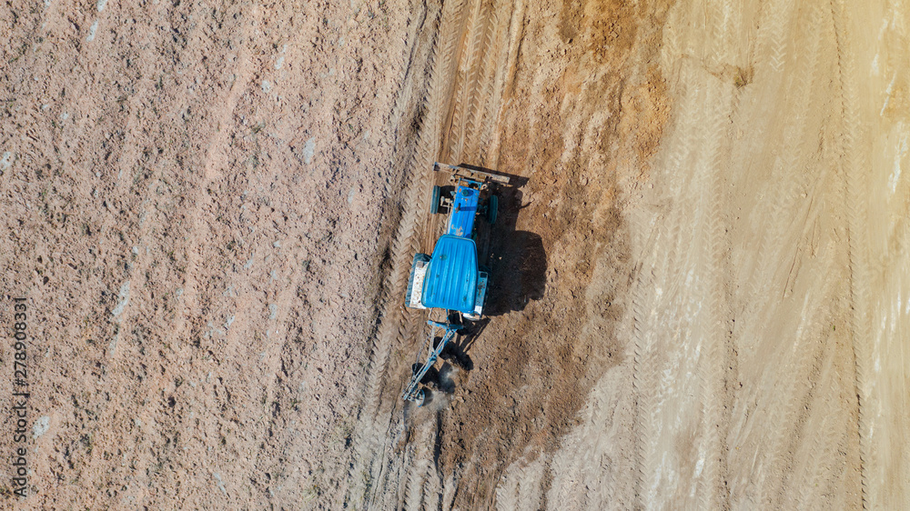 Top view of agricultural tractor vehicles working at field Top view of agricultural tractor vehicles working at field