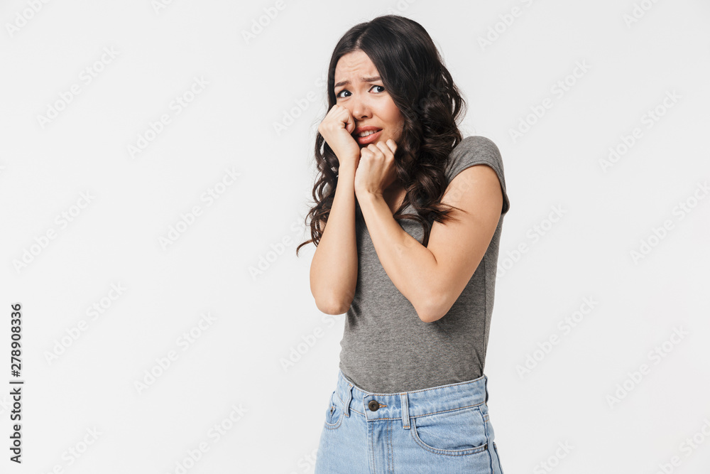 Image of shocked brunette woman 20s dressed in basic clothes grabbing her face in fright Image of shocked brunette woman 20s dressed in basic clothes grabbing her face in fright