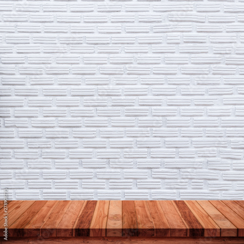 Empty wood table with white brick wall background.