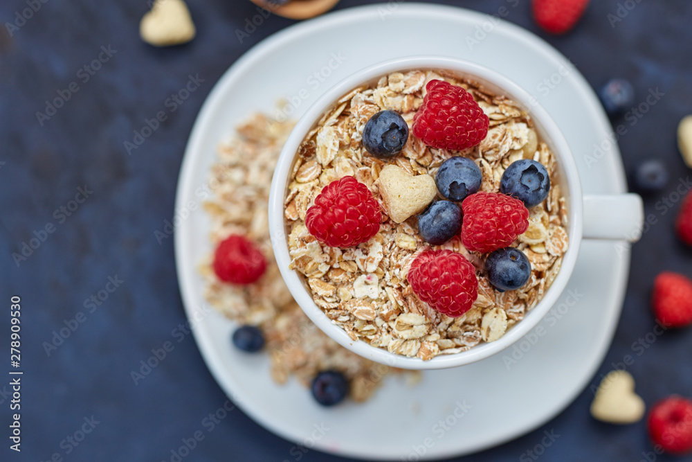 Raspberries and blueberries on blue background. Cereals. Raspberries and blueberries on blue background. Cereals.